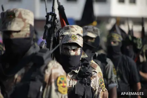 Members of the Palestinian Islamic Jihad movement parade with guns on November 13, 2013 in the streets of Gaza City during an anti-Israel march as part of the celebrations marking the first anniversary of Israel's Operat...