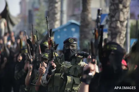 Members of the Palestinian Islamic Jihad movement parade with guns on November 13, 2013 in the streets of Gaza City during an anti-Israel march as part of the celebrations marking the first anniversary of Israel's Operat...
