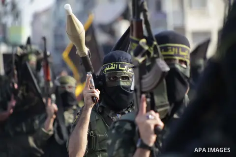 Members of the Palestinian Islamic Jihad movement parade with guns on November 13, 2013 in the streets of Gaza City during an anti-Israel march as part of the celebrations marking the first anniversary of Israel's Operat...