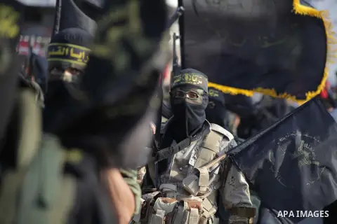 Members of the Palestinian Islamic Jihad movement parade with guns on November 13, 2013 in the streets of Gaza City during an anti-Israel march as part of the celebrations marking the first anniversary of Israel's Operat...