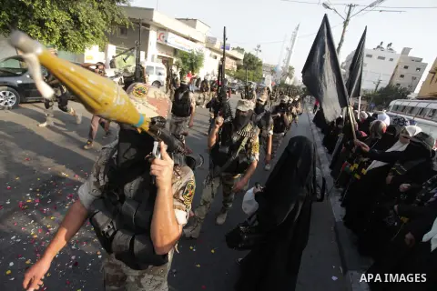 Members of the Palestinian Islamic Jihad movement parade with guns on November 13, 2013 in the streets of Gaza City during an anti-Israel march as part of the celebrations marking the first anniversary of Israel's Operat...