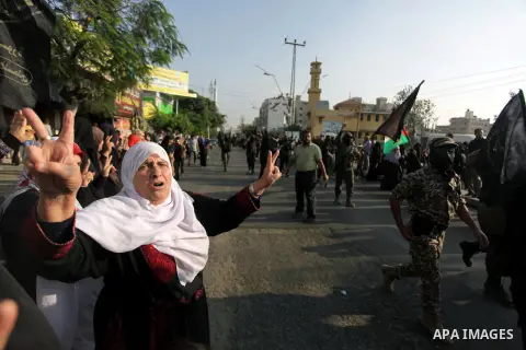 Members of the Palestinian Islamic Jihad movement parade with guns on November 13, 2013 in the streets of Gaza City during an anti-Israel march as part of the celebrations marking the first anniversary of Israel's Operat...