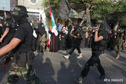 Members of the Palestinian Islamic Jihad movement parade with guns on November 13, 2013 in the streets of Gaza City during an anti-Israel march as part of the celebrations marking the first anniversary of Israel's Operat...
