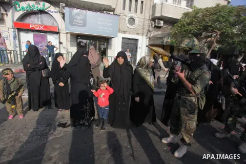 Members of the Palestinian Islamic Jihad movement parade with guns on November 13, 2013 in the streets of Gaza City during an anti-Israel march as part of the celebrations marking the first anniversary of Israel's Operat...
