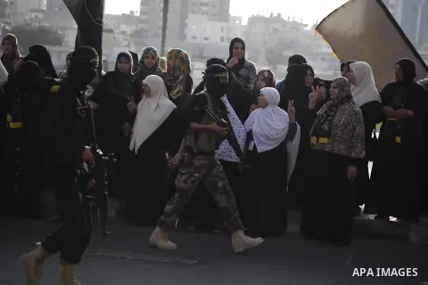 Members of the Palestinian Islamic Jihad movement parade with guns on November 13, 2013 in the streets of Gaza City during an anti-Israel march as part of the celebrations marking the first anniversary of Israel's Operat...
