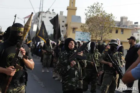 A female militant of the Palestinian Islamic Jihad movement holds a weapon during an anti-Israeli march on November 13, 2013 in the streets of Gaza City as part of the celebrations marking the first anniversary of Israel...