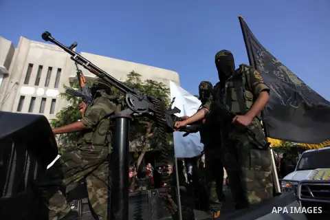 Members of the Palestinian Islamic Jihad movement parade with guns on November 13, 2013 in the streets of Gaza City during an anti-Israel march as part of the celebrations marking the first anniversary of Israel's Operat...