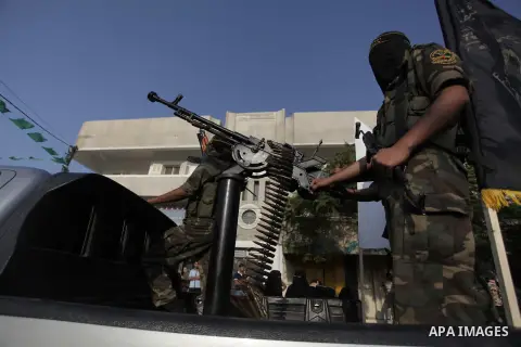 Members of the Palestinian Islamic Jihad movement parade with guns on November 13, 2013 in the streets of Gaza City during an anti-Israel march as part of the celebrations marking the first anniversary of Israel's Operat...