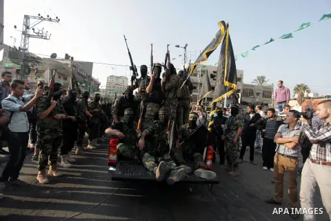 Members of the Palestinian Islamic Jihad movement parade with guns on November 13, 2013 in the streets of Gaza City during an anti-Israel march as part of the celebrations marking the first anniversary of Israel's Operat...