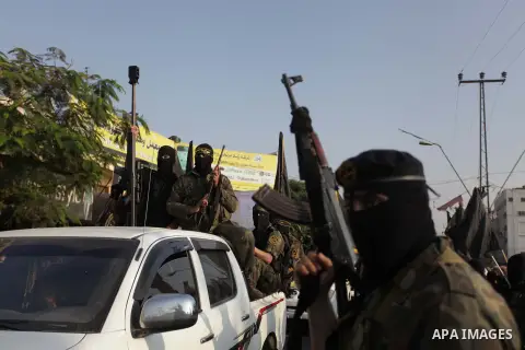 Members of the Palestinian Islamic Jihad movement parade with guns on November 13, 2013 in the streets of Gaza City during an anti-Israel march as part of the celebrations marking the first anniversary of Israel's Operat...