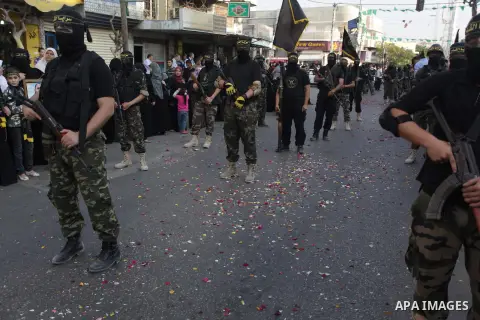 Members of the Palestinian Islamic Jihad movement parade with guns on November 13, 2013 in the streets of Gaza City during an anti-Israel march as part of the celebrations marking the first anniversary of Israel's Operat...