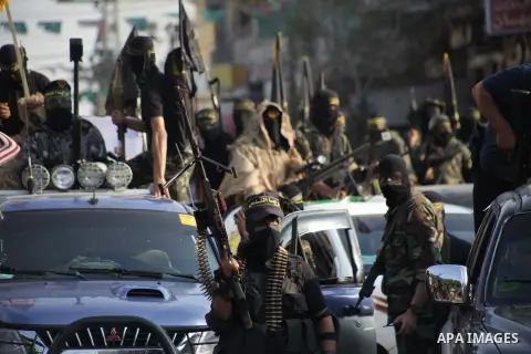 Members of the Palestinian Islamic Jihad movement parade with guns on November 13, 2013 in the streets of Gaza City during an anti-Israel march as part of the celebrations marking the first anniversary of Israel's Operat...