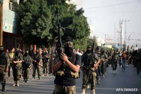 Members of the Palestinian Islamic Jihad movement parade with guns on November 13, 2013 in the streets of Gaza City during an anti-Israel march as part of the celebrations marking the first anniversary of Israel's Operat...