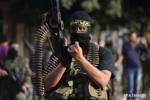 Members of the Palestinian Islamic Jihad movement parade with guns on November 13, 2013 in the streets of Gaza City during an anti-Israel march as part of the celebrations marking the first anniversary of Israel's Operat...