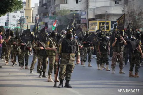 Members of the Palestinian Islamic Jihad movement parade with guns on November 13, 2013 in the streets of Gaza City during an anti-Israel march as part of the celebrations marking the first anniversary of Israel's Operat...