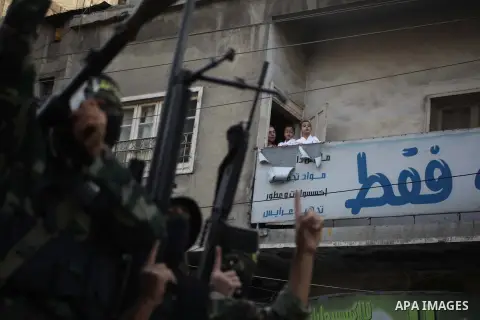 Members of the Palestinian Islamic Jihad movement parade with guns on November 13, 2013 in the streets of Gaza City during an anti-Israel march as part of the celebrations marking the first anniversary of Israel's Operat...