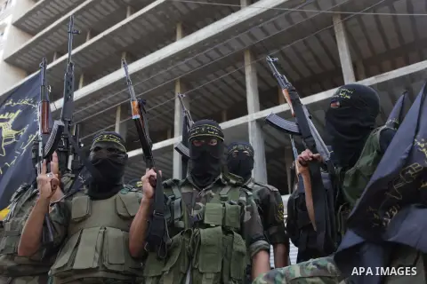 Members of the Palestinian Islamic Jihad movement parade with guns on November 13, 2013 in the streets of Gaza City during an anti-Israel march as part of the celebrations marking the first anniversary of Israel's Operat...