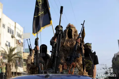 Members of the Palestinian Islamic Jihad movement parade with guns on November 13, 2013 in the streets of Gaza City during an anti-Israel march as part of the celebrations marking the first anniversary of Israel's Operat...
