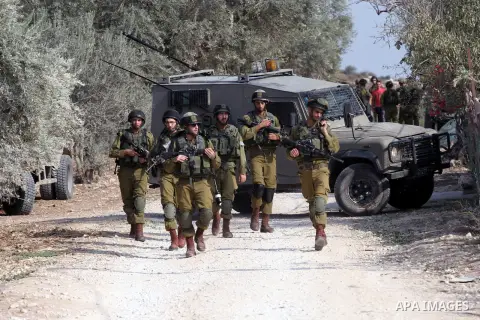 Israeli security forces patrol the street in the West Bank village of Bir al-Basha, near Jenin, on November 13, 2013. Israeli forces raided the home of Hussein Sharif Ghawadra, 16, a suspected of stabbing an Israeli sold...