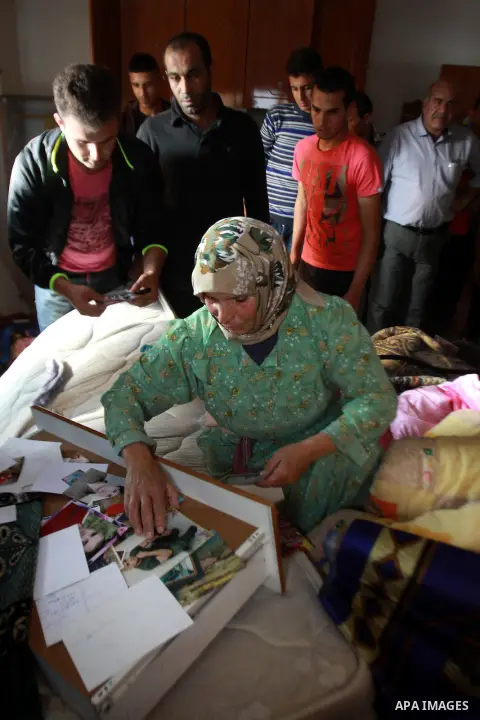A Palestinian woman inspects her home after raided by Israeli security forces in the West Bank village of Bir al-Basha, near Jenin, on November 13, 2013. Israeli forces raided the home of Hussein Sharif Ghawadra, 16, a s...