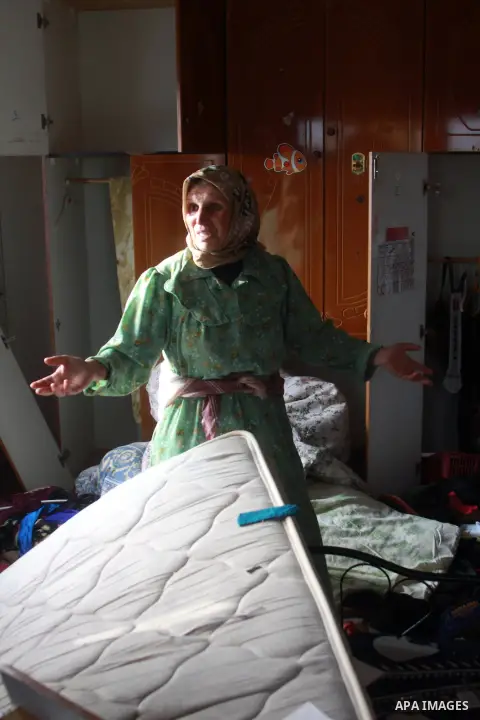 A Palestinian woman inspects her home after raided by Israeli security forces in the West Bank village of Bir al-Basha, near Jenin, on November 13, 2013. Israeli forces raided the home of Hussein Sharif Ghawadra, 16, a s...