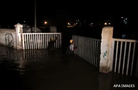 Palestinian workers work in a flooded street with sewage in al-Sabra neighborhood, in Gaza City on November 13, 2013. The main pump of sewage water which serves thousands of citizens in a densely populated area was stope...