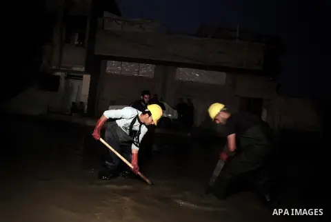 Palestinian workers work in a flooded street with sewage in al-Sabra neighborhood, in Gaza City on November 13, 2013. The main pump of sewage water which serves thousands of citizens in a densely populated area was stope...