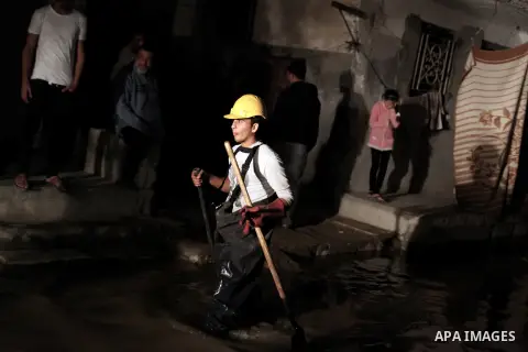 A Palestinian worker wrorks in a flooded street with sewage in al-Sabra neighborhood, in Gaza City on November 13, 2013. The main pump of sewage water which serves thousands of citizens in a densely populated area was st...