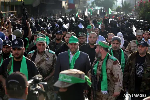 Palestinian militants of the Ezzedine al-Qassam Brigades, Hamas's armed wing, stage an anti-Israel parade as part of the celebrations marking the first anniversary of an Israeli army operation in Gaza, on November 14, 20...