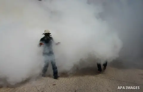 Palestinian protesters throw stone towards Israeli security forces during clashes following a protest against the expropriation of Palestinian land by Israel in the village of Kfar Qaddum, near the occupied West Bank cit...
