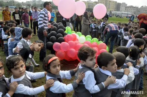 Palestinian children hold balloons in the colour of the national flag to mark the 25th anniversary of the Palestinian Independence Day, in Gaza city, on Nov. 17, 2013. Palestinians have marked Nov. 15 as their Independen...