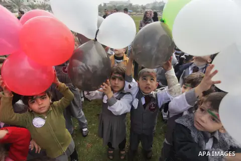Palestinians hold balloons in the colour of the national flag to mark the 25th anniversary of the Palestinian Independence Day, in Gaza city, on Nov. 17, 2013. Palestinians have marked Nov. 15 as their Independence Day s...