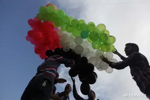 Palestinians hold balloons in the colour of the national flag to mark the 25th anniversary of the Palestinian Independence Day, in Gaza city, on Nov. 17, 2013. Palestinians have marked Nov. 15 as their Independence Day s...