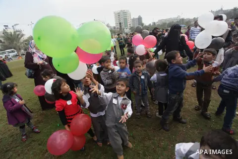 Palestinians hold balloons in the colour of the national flag to mark the 25th anniversary of the Palestinian Independence Day, in Gaza city, on Nov. 17, 2013. Palestinians have marked Nov. 15 as their Independence Day s...