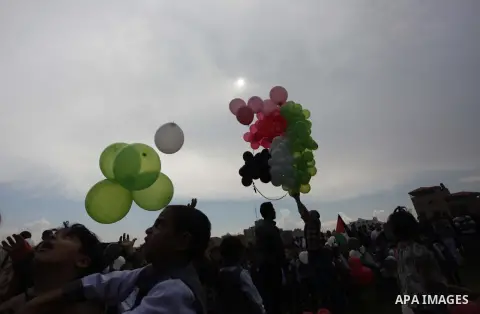 Palestinians hold balloons in the colour of the national flag to mark the 25th anniversary of the Palestinian Independence Day, in Gaza city, on Nov. 17, 2013. Palestinians have marked Nov. 15 as their Independence Day s...