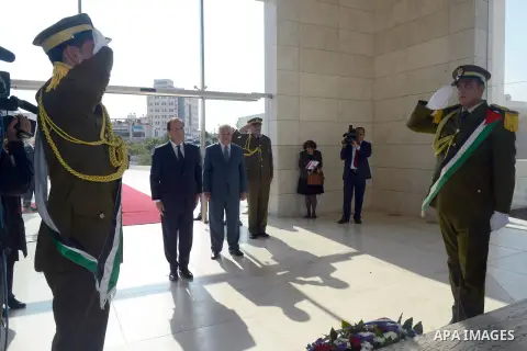 French President Francois Hollande lays a wreath at the grave of late Palestinian leader Yasser Arafat, in the West Bank city of Ramallah, on November 18, 2013. Hollande is expected to meet with Palestinian leaders for t...