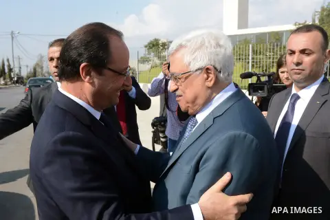 Palestinian President Mahmoud Abbas greets French President Francois Hollande as he leaves, in the West Bank city of Ramallah, on November 18, 2013. Hollande is expected to meet with Palestinian leaders for talks on trou...