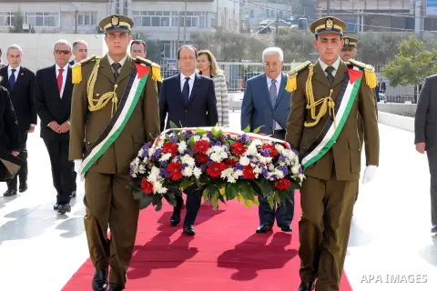 Palestinian President Mahmoud Abbas, and French President Francois Hollande walk past an honor guard during a welcoming ceremony in the West Bank city of Ramallah, on November 18, 2013. Hollande is expected to meet with...