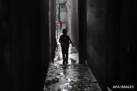 A Palestinian boy walks in a flooded street during a rainy day at al-Shati refugee camp, the third largest in the Palestinian Territories, in Gaza City on November 11, 2013. Photo by Mohammed Talatene