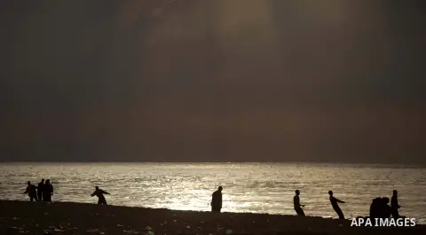 Palestinian fishermen retrieve their net during a rainy day at the beach of Gaza City, on November 18, 2013. Photo by Ashraf Amra