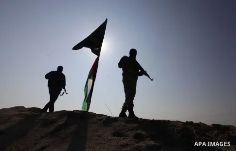 Palestinians Islamic Jihad (PIJ) militant inspect a training camp which witnesses said was targeted in an overnight Israeli air strike in Beit Lahiya in the northern Gaza Strip November 20, 2013. Photo by Ashraf Amra