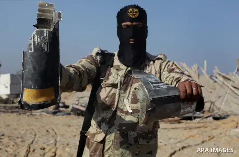 A Palestinian Islamic Jihad (PIJ) militant inspects a training camp which witnesses said was targeted in an overnight Israeli air strike in Beit Lahiya in the northern Gaza Strip November 20, 2013. Photo by Ashraf Amra