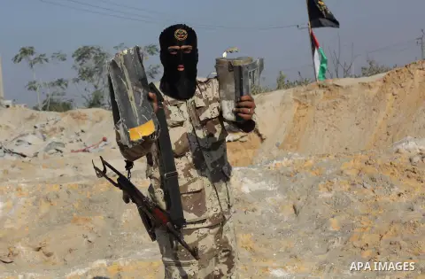 A Palestinian Islamic Jihad (PIJ) militant inspects a training camp which witnesses said was targeted in an overnight Israeli air strike in Beit Lahiya in the northern Gaza Strip November 20, 2013. Photo by Ashraf Amra