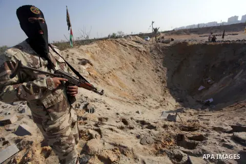 A Palestinian Islamic Jihad (PIJ) militant inspects a training camp which witnesses said was targeted in an overnight Israeli air strike in Beit Lahiya in the northern Gaza Strip November 20, 2013. Photo by Ashraf Amra