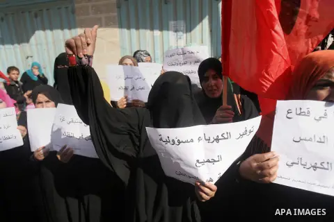 Palestinian women take part in a protest against the severe fuel cuts that lead to power shortages and the siege, in front of the electricity company in Rafah southern Gaza city, November 21, 2013. Gaza strip lone power...