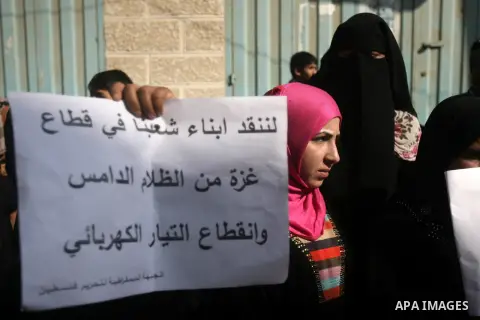 Palestinian women take part in a protest against the severe fuel cuts that lead to power shortages and the siege, in front of the electricity company in Rafah southern Gaza city, November 21, 2013. Gaza strip lone power...
