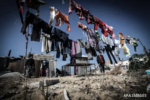 Palestinian children play outside their tin shacks in Khan Younis refugee camp, in southern Gaza Strip, November 21, 2013. The UNRWA, which is facing a 36-million dollar deficit, halted 19 out of 20 construction projects...
