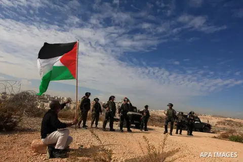 A Palestinian man argues with Israeli border policemen during the weekly demonstration against Israel's separation barrier in the West Bank village of Bilin, near Ramallah, Friday, Nov. 22, 2013. Photo by Issam Rimawi