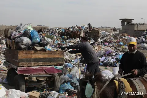 Palestinian workers of the Gaza municipality collect rubbish at a landfill sites in the compound of Yarmouk, in Gaza city, on Nov. 24, 2013. Gaza Municipality announced stop working its waste cars due to a fuel shortage....