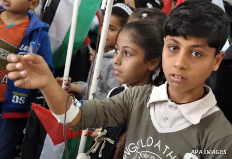 Palestinian students take part a protest against the Israeli blockade on the Gaza Strip, at al-Rantisi hospital, in Gaza city, on Nov. 26, 2013. Gaza has been almost entirely without fuel for weeks, and the resulting shu...
